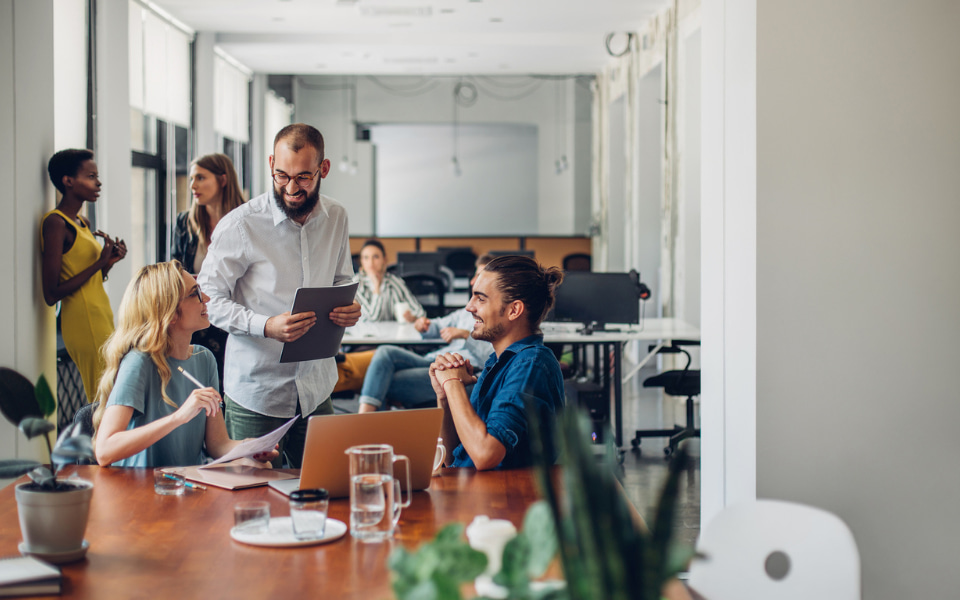 Three people smiling at work