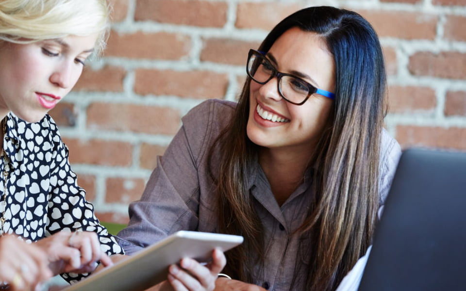 Woman smiling at another woman